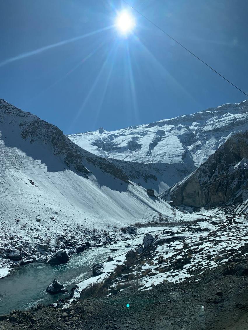 Winter sun over a snowy river valley
