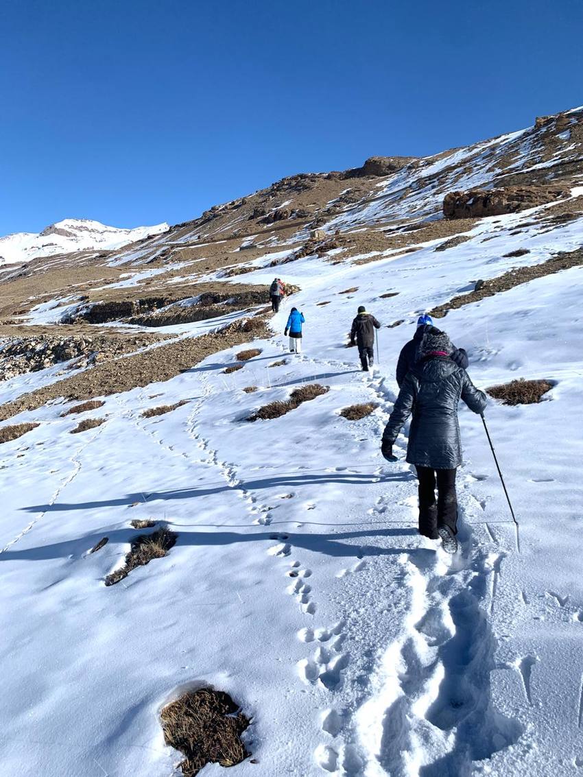 Walking uphill across snow-covered slopes